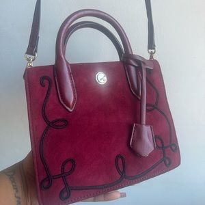 Red velvet purse with embroidery.